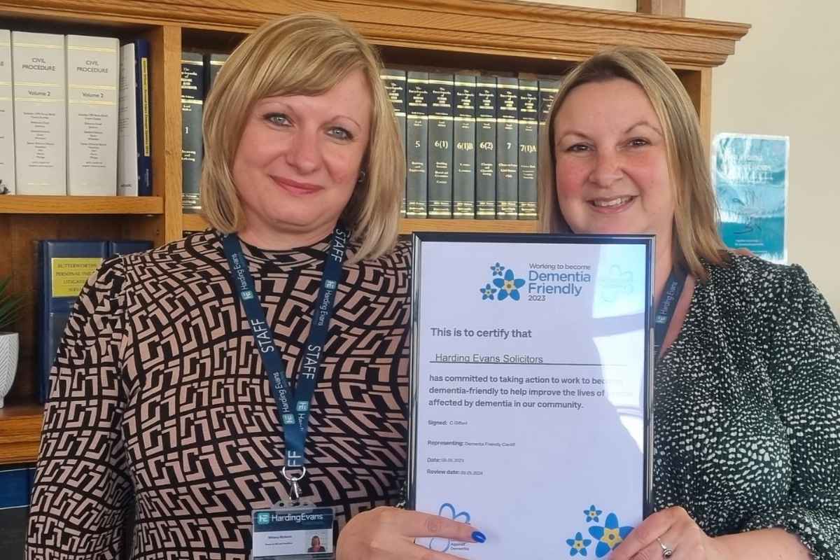 Harding Evans staff holding a Dementia Friendly certificate. 